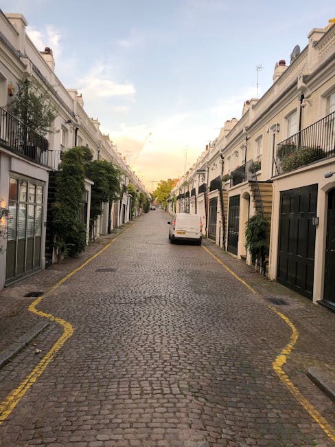 A multi-storey white Victorian townhouse with ornate architectural details including decorative cornices and large sash windows, situated on Wilton Crescent in Belgravia. The building features black w